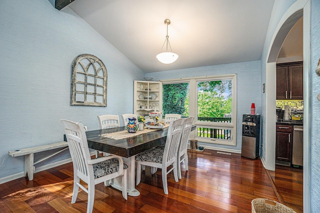 191 S Lake Doster Dr, Plainwell, MI 49080 - dining area with lofted ceiling, arched walkways, and dark wood-style flooring
