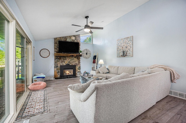 191 S Lake Doster Dr, Plainwell, MI 49080 - living room with ceiling fan, a fireplace, wood finished floors, and vaulted ceiling