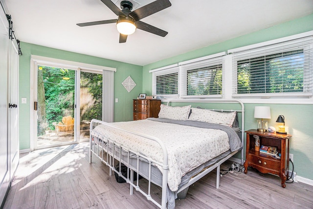 191 S Lake Doster Dr, Plainwell, MI 49080 - bedroom featuring access to exterior, wood finished floors, and a ceiling fan