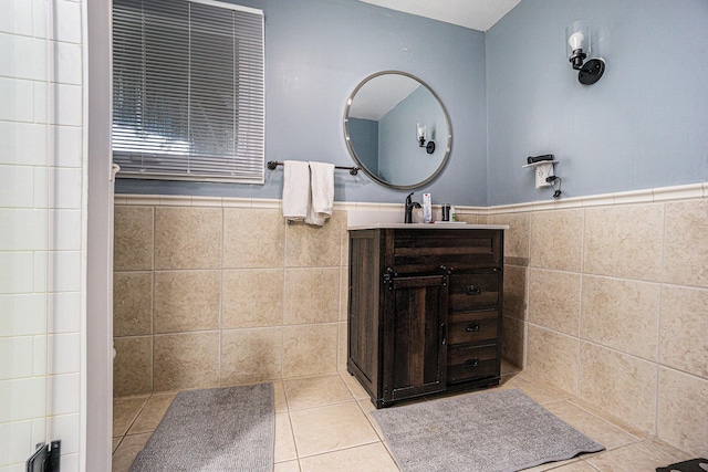 191 S Lake Doster Dr, Plainwell, MI 49080 - bathroom featuring tile walls, vanity, tile patterned floors, and wainscoting