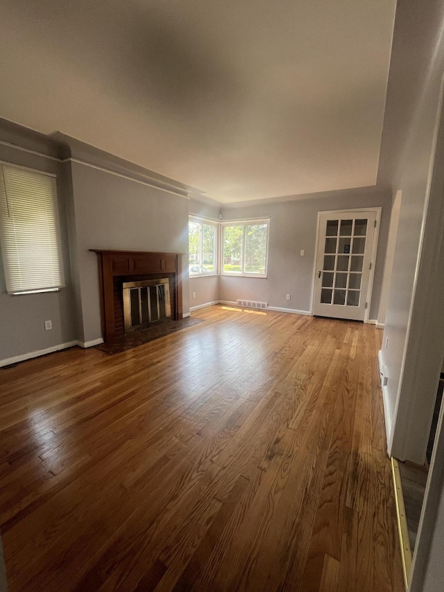 16609 Edmore Dr, Detroit, MI 48205 - unfurnished living room featuring wood finished floors and a fireplace with flush hearth