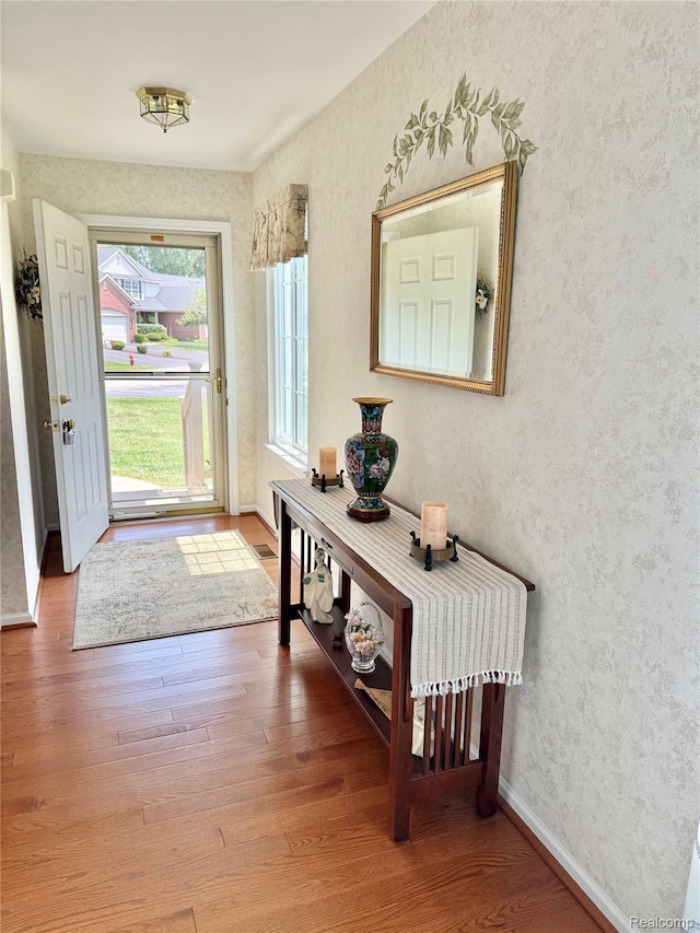 6426 Club Ct W, Grand Blanc, MI 48439 - entryway featuring wood finished floors and wallpapered walls