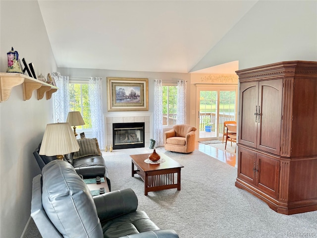 6426 Club Ct W, Grand Blanc, MI 48439 - living area with healthy amount of natural light, light carpet, a tile fireplace, and high vaulted ceiling
