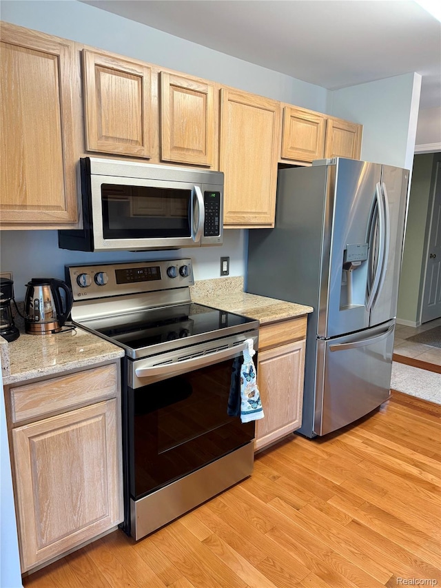 6426 Club Ct W, Grand Blanc, MI 48439 - kitchen with appliances with stainless steel finishes, light brown cabinetry, light wood-type flooring, and light stone countertops