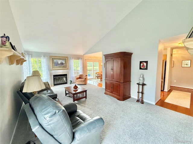 6426 Club Ct W, Grand Blanc, MI 48439 - carpeted living area with high vaulted ceiling and a tiled fireplace