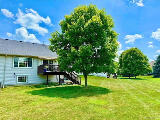 6426 Club Ct W, Grand Blanc, MI 48439 - view of grassy yard featuring stairs and a wooden deck