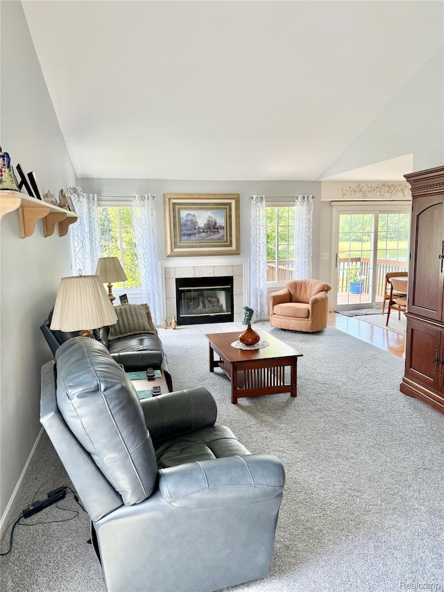 6426 Club Ct W, Grand Blanc, MI 48439 - living area with lofted ceiling, carpet, and a tile fireplace