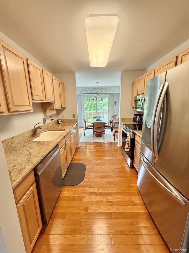 6426 Club Ct W, Grand Blanc, MI 48439 - kitchen with stainless steel appliances, light brown cabinets, and light wood finished floors