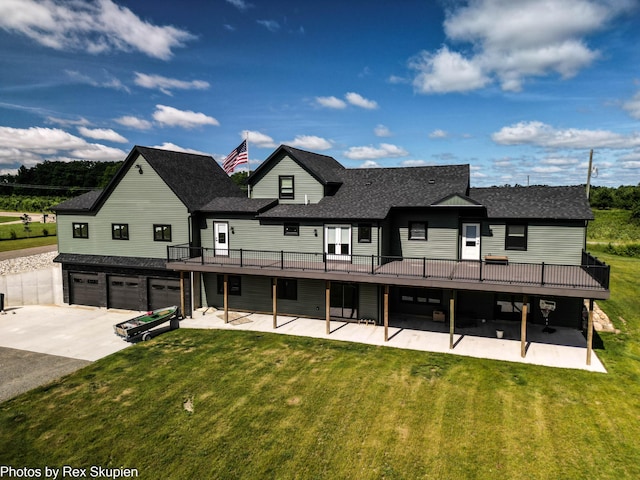 17090 Kenowa Ave, Kent City, MI 49330 - rear view of house with an attached garage, a wooden deck, a yard, and concrete driveway