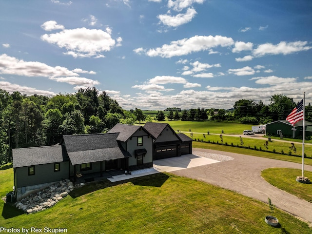 17090 Kenowa Ave, Kent City, MI 49330 - view of front of house with driveway, a front lawn, a garage, and a shingled roof