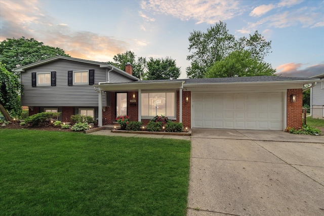 20955 Robinwood St, Farmington, MI 48336 - split level home featuring brick siding, a chimney, and an attached garage