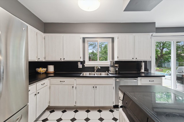 20955 Robinwood St, Farmington, MI 48336 - kitchen featuring appliances with stainless steel finishes, dark countertops, healthy amount of natural light, and light floors