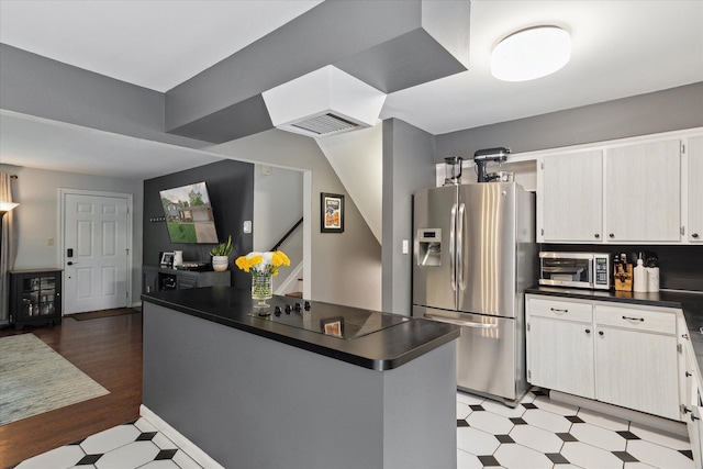 20955 Robinwood St, Farmington, MI 48336 - kitchen featuring stainless steel appliances, dark countertops, light floors, and white cabinetry