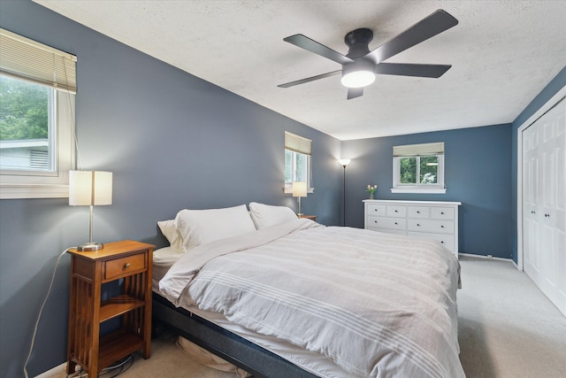 20955 Robinwood St, Farmington, MI 48336 - bedroom with light carpet, a textured ceiling, a closet, multiple windows, and a ceiling fan