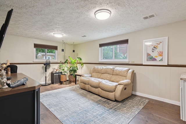 20955 Robinwood St, Farmington, MI 48336 - living area with healthy amount of natural light, wood finished floors, wainscoting, and a textured ceiling
