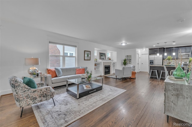 715 Gardenia Ave, Royal Oak, MI 48067 - living room featuring dark wood-style floors and a brick fireplace