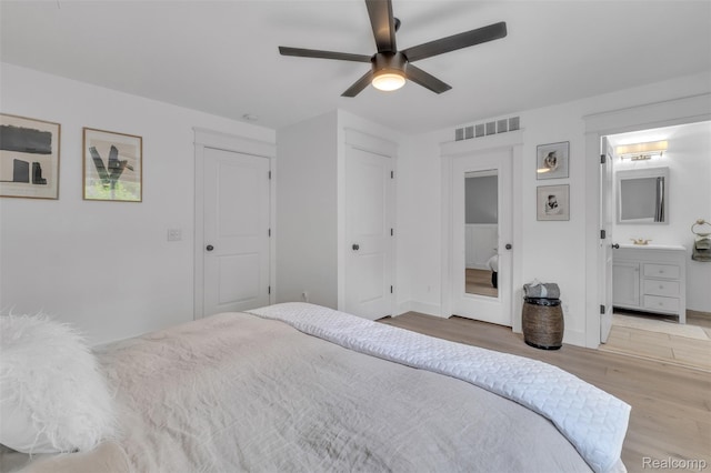715 Gardenia Ave, Royal Oak, MI 48067 - bedroom featuring wood finished floors, ensuite bathroom, and ceiling fan