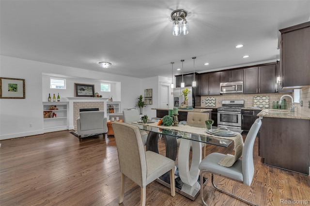 715 Gardenia Ave, Royal Oak, MI 48067 - dining room with a fireplace, dark wood-style flooring, and recessed lighting