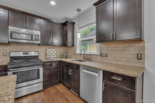 715 Gardenia Ave, Royal Oak, MI 48067 - kitchen featuring appliances with stainless steel finishes, dark brown cabinets, light stone counters, dark wood finished floors, and recessed lighting