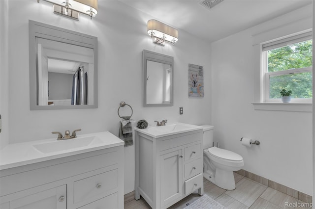 715 Gardenia Ave, Royal Oak, MI 48067 - bathroom featuring two vanities and toilet