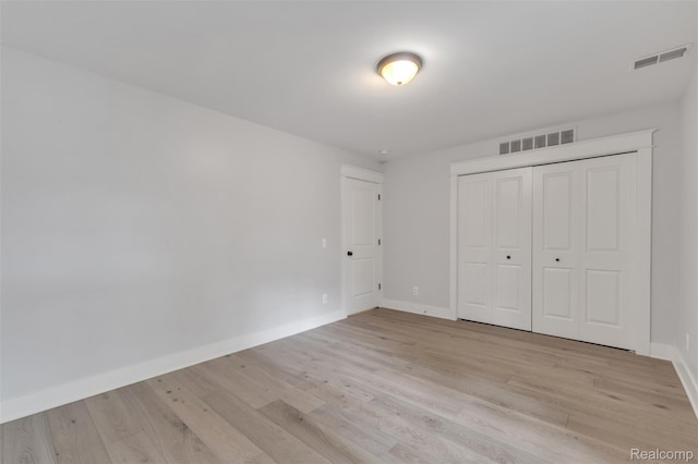 715 Gardenia Ave, Royal Oak, MI 48067 - unfurnished bedroom featuring light wood finished floors and a closet