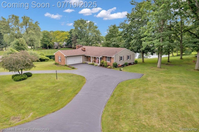 1526 Rulane Dr, Lapeer, MI 48446 - ranch-style house featuring asphalt driveway, a garage, a front yard, brick siding, and view of wooded area
