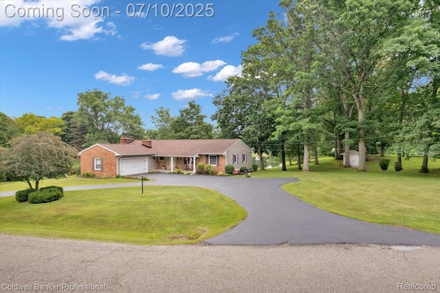 1526 Rulane Dr, Lapeer, MI 48446 - ranch-style home with curved driveway, a front yard, an attached garage, and brick siding