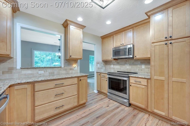 1526 Rulane Dr, Lapeer, MI 48446 - kitchen featuring appliances with stainless steel finishes, light brown cabinetry, light wood-style floors, tasteful backsplash, and recessed lighting