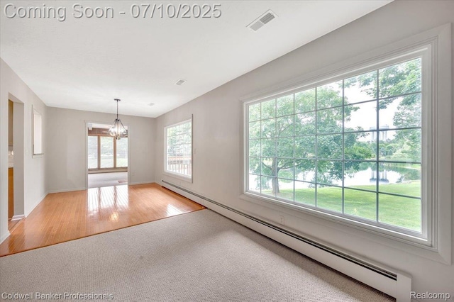 1526 Rulane Dr, Lapeer, MI 48446 - carpeted spare room featuring a chandelier, wood finished floors, a water view, and a baseboard heating unit