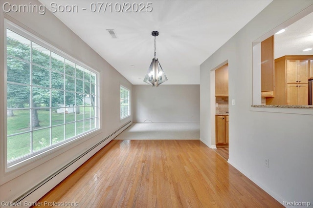 1526 Rulane Dr, Lapeer, MI 48446 - unfurnished room featuring baseboard heating, a chandelier, and light wood-style floors