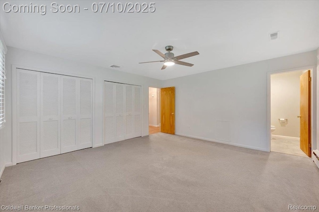 1526 Rulane Dr, Lapeer, MI 48446 - unfurnished bedroom featuring multiple closets, carpet, a ceiling fan, and ensuite bathroom