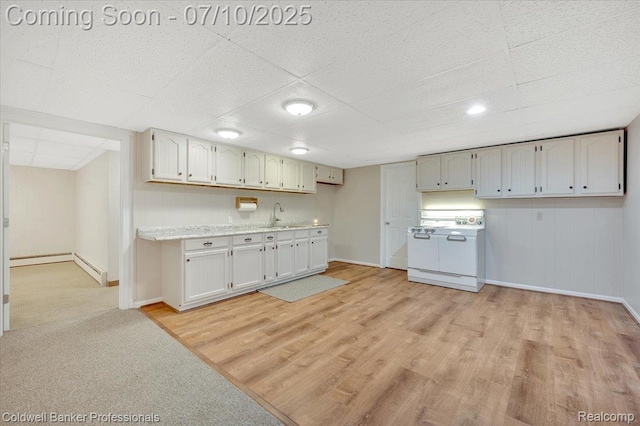 1526 Rulane Dr, Lapeer, MI 48446 - kitchen with range, a drop ceiling, light wood-style floors, light countertops, and a baseboard heating unit