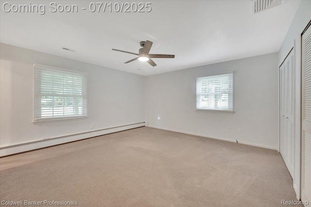1526 Rulane Dr, Lapeer, MI 48446 - unfurnished bedroom featuring a baseboard heating unit, carpet, multiple windows, and a closet