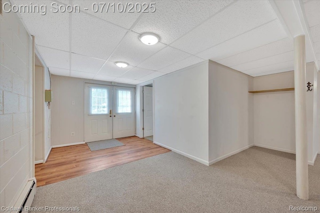 1526 Rulane Dr, Lapeer, MI 48446 - basement with a baseboard radiator, carpet floors, a drop ceiling, and wood finished floors