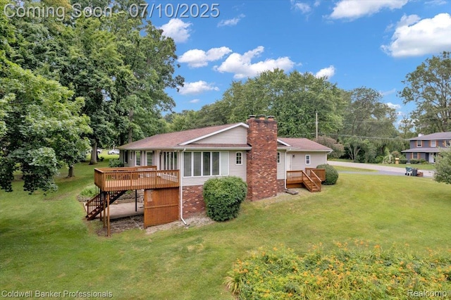 1526 Rulane Dr, Lapeer, MI 48446 - back of property featuring stairway, a deck, a chimney, and a lawn
