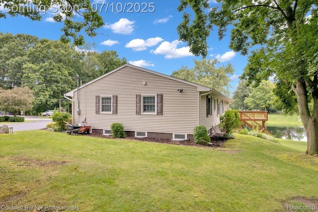 1526 Rulane Dr, Lapeer, MI 48446 - view of side of property featuring a yard and a deck with water view