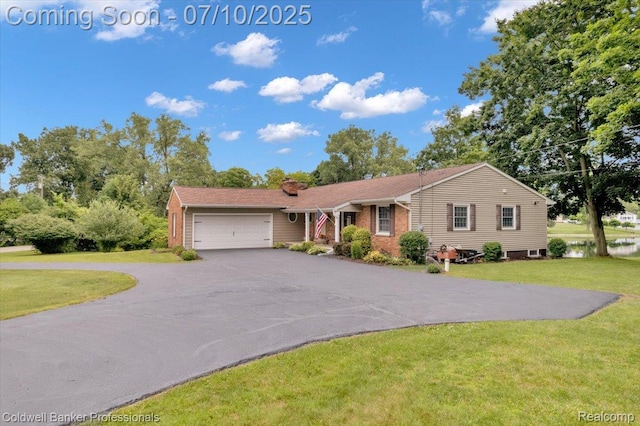 1526 Rulane Dr, Lapeer, MI 48446 - ranch-style home featuring driveway, a garage, a front yard, and brick siding