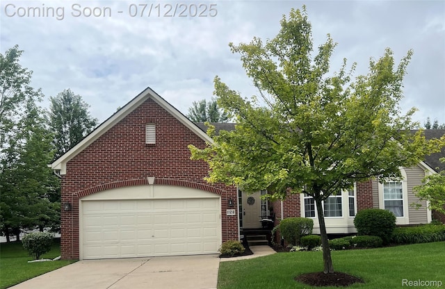 1128 Andover Cir, Commerce Twp, MI 48390 - obstructed view of property with brick siding, driveway, and a front lawn