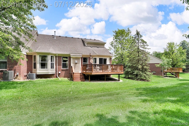 1128 Andover Cir, Commerce Twp, MI 48390 - back of property featuring a wooden deck, a yard, a shingled roof, and brick siding