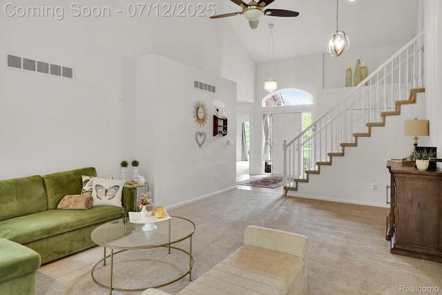 1128 Andover Cir, Commerce Twp, MI 48390 - living room with a high ceiling, stairs, a ceiling fan, carpet flooring, and a chandelier