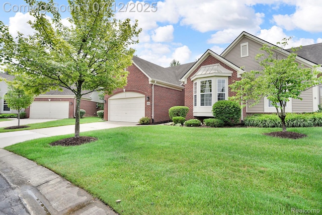 1128 Andover Cir, Commerce Twp, MI 48390 - view of front facade with brick siding, driveway, a front yard, a garage, and roof with shingles