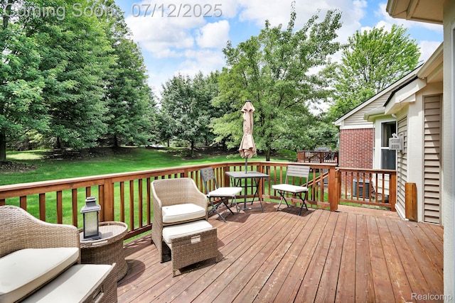 1128 Andover Cir, Commerce Twp, MI 48390 - deck featuring a lawn and view of wooded area