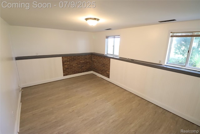 9360 Gale Rd, Goodrich, MI 48438 - unfurnished room featuring wood finished floors and brick wall