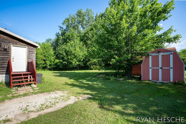 5886 W Clarksville Rd, Lake Odessa, MI 48849 - view of green lawn with entry steps and a shed