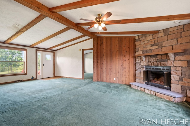 5886 W Clarksville Rd, Lake Odessa, MI 48849 - unfurnished living room with a fireplace, carpet, wood walls, and ceiling fan