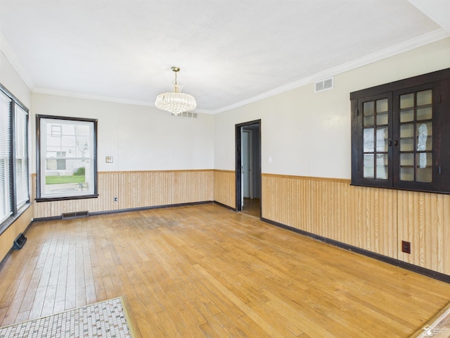4356 14th St, Luna Pier, MI 48157 - unfurnished room with hardwood / wood-style floors, a chandelier, wainscoting, and crown molding