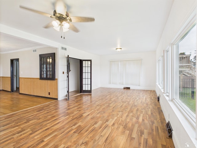 4356 14th St, Luna Pier, MI 48157 - unfurnished living room featuring light wood-style floors, a ceiling fan, and a wainscoted wall