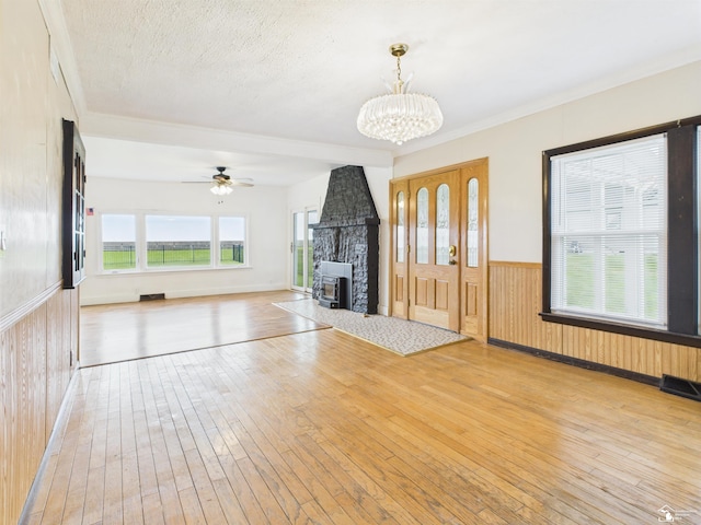 4356 14th St, Luna Pier, MI 48157 - unfurnished living room featuring wood-type flooring, a wainscoted wall, a chandelier, wood walls, and ceiling fan