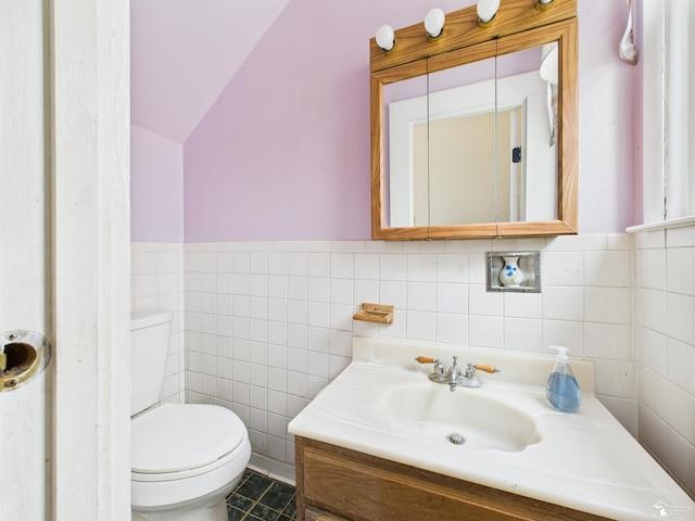 4356 14th St, Luna Pier, MI 48157 - bathroom featuring vanity, vaulted ceiling, and tile walls