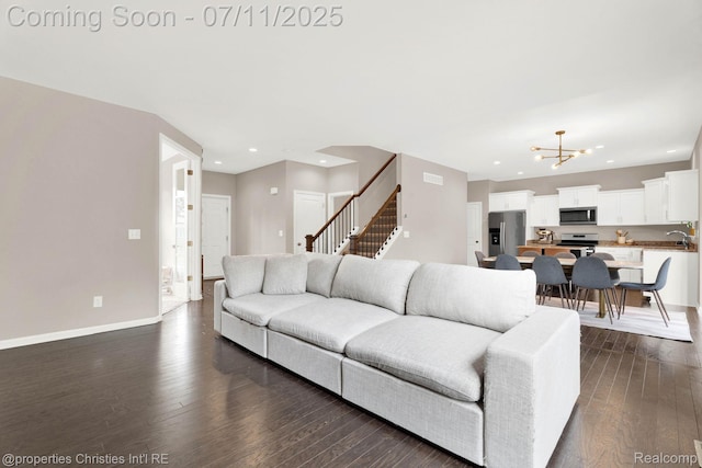 2962 Iowa Dr, Troy, MI 48083 - living area featuring dark wood finished floors, recessed lighting, stairs, and a chandelier